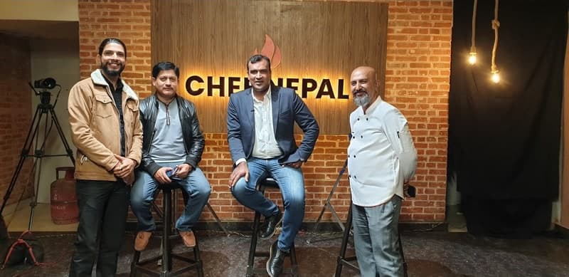 Samir with guests and a chef on the Chef Nepal set